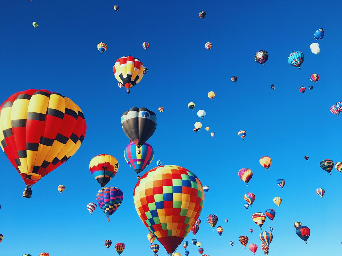 A vibrant hot air balloon festival filling the sky with colorful orbs.