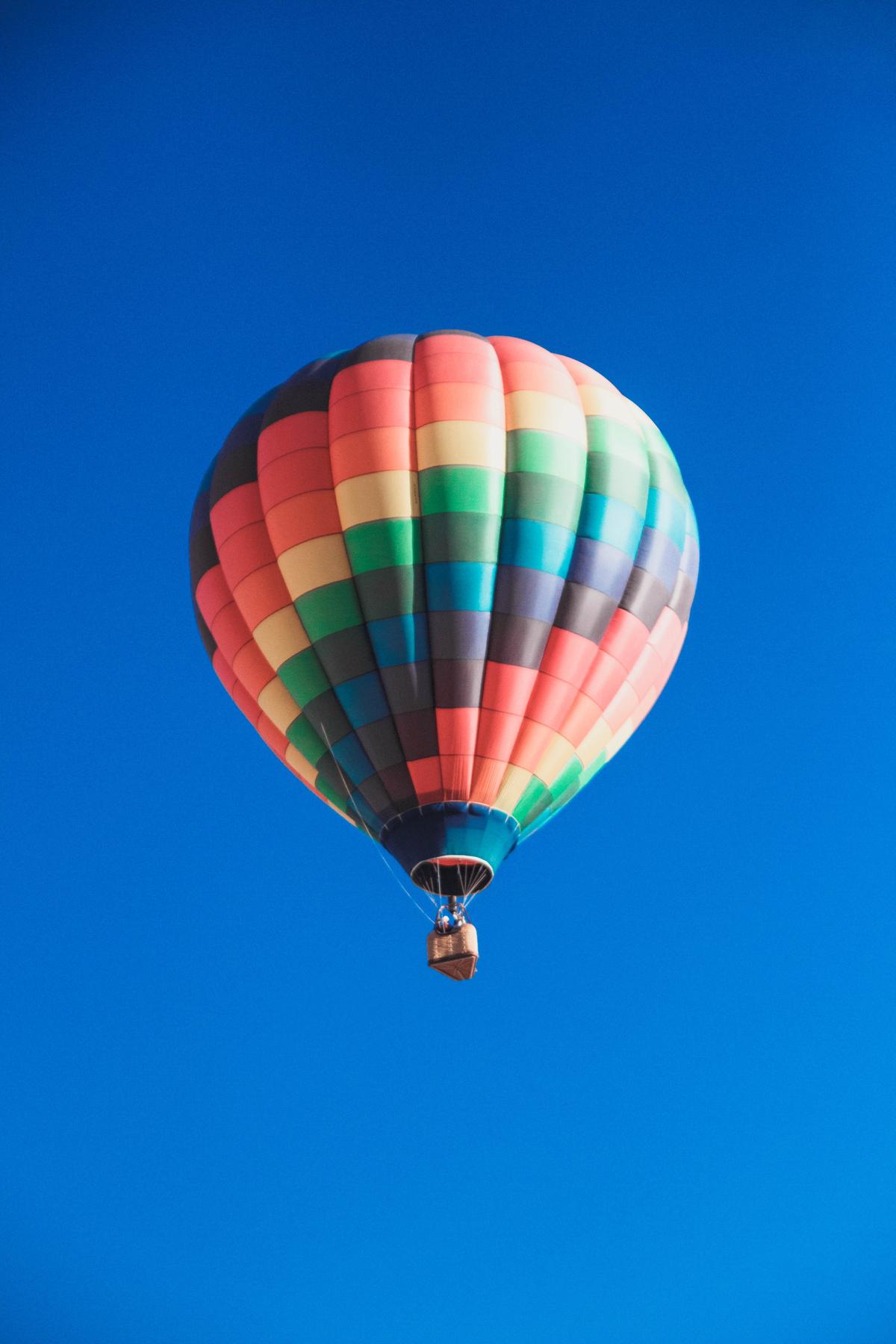 A colorful hot air balloon soaring above the picturesque landscape of Albuquerque.