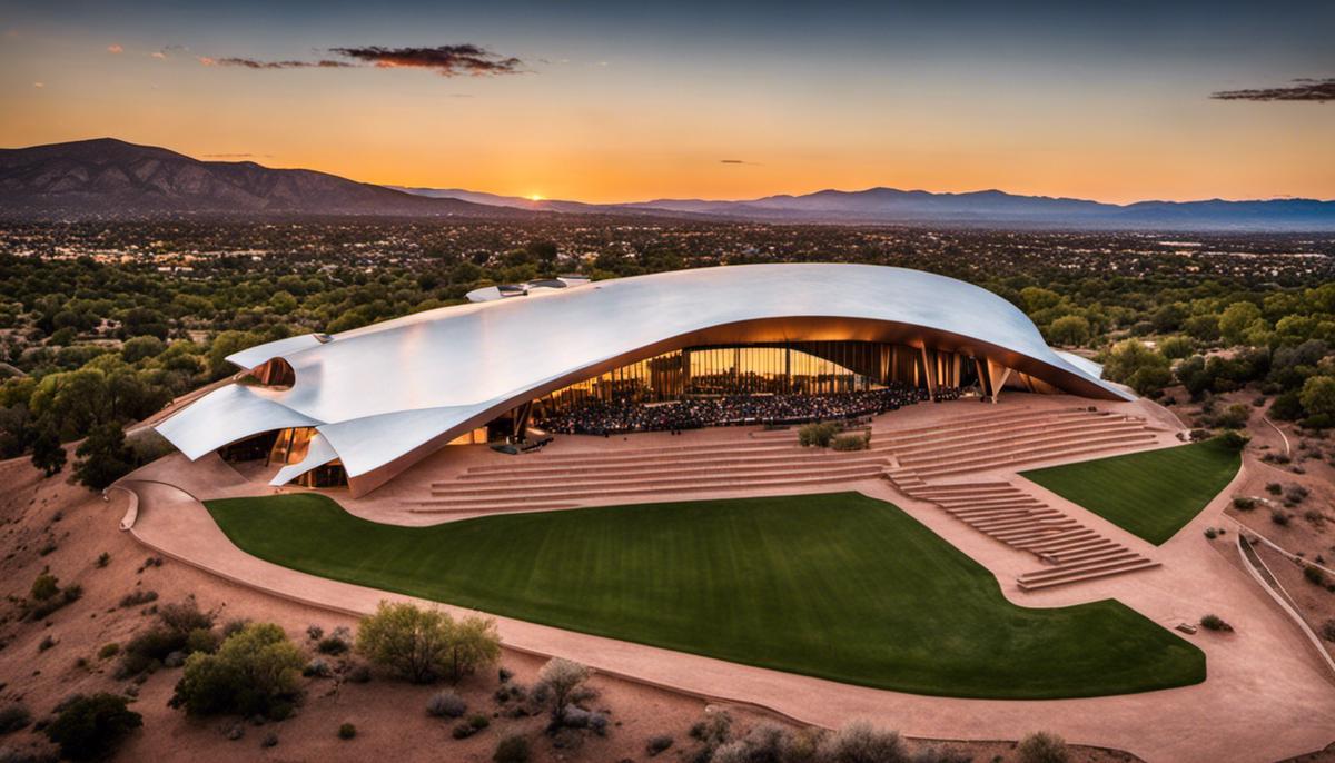 The Santa Fe Opera House at sunset, with the desert landscape in the background.