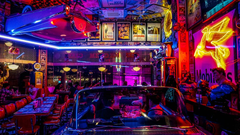 Image of vibrant South Beach nightlife, showcasing neon lights and a bustling crowd